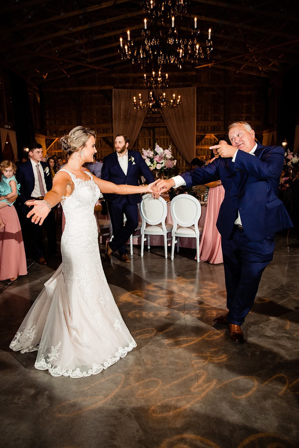 Father and daughter having fun dancing during her wedding reception