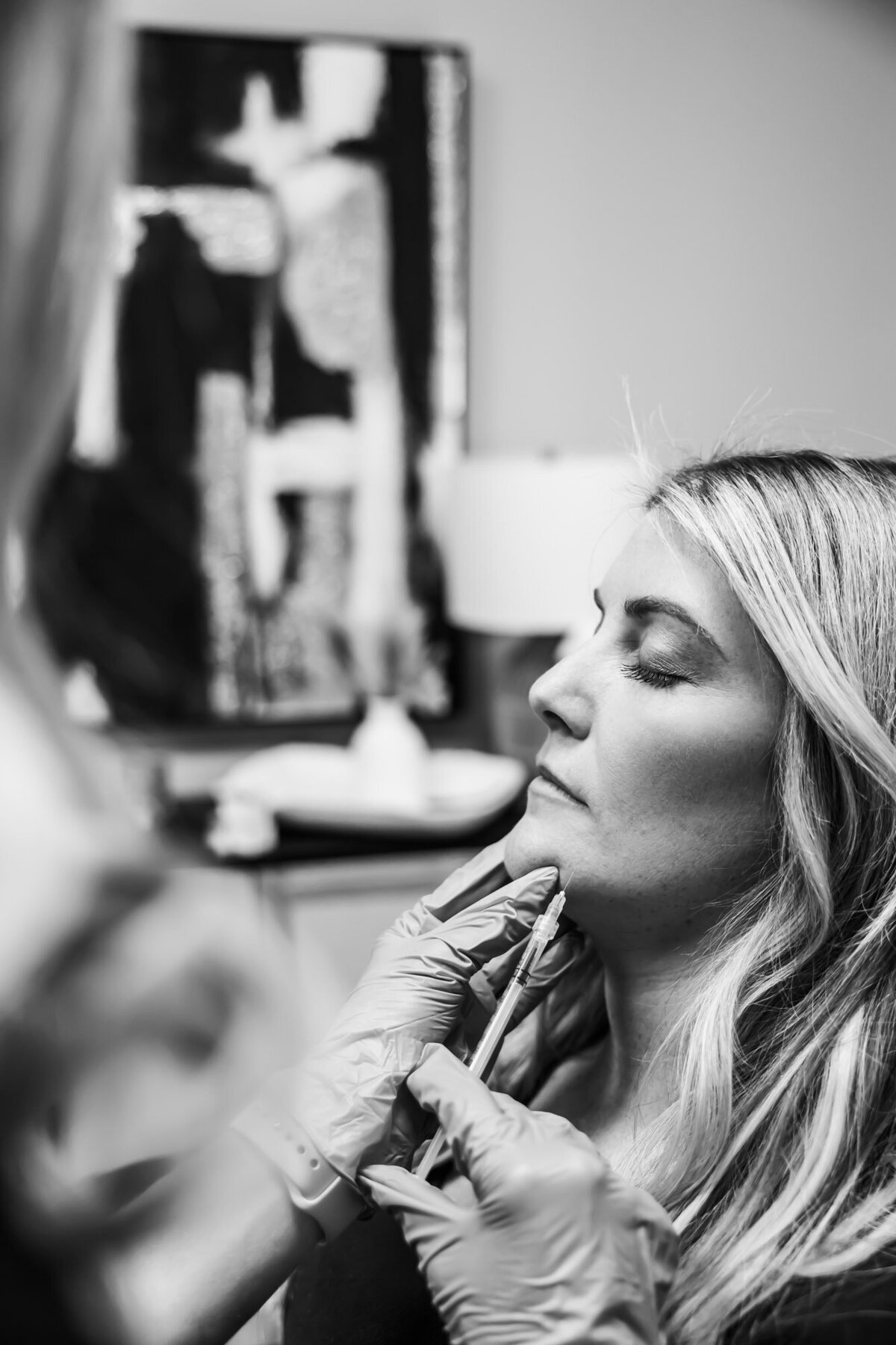 Woman receiving an injection on her chin