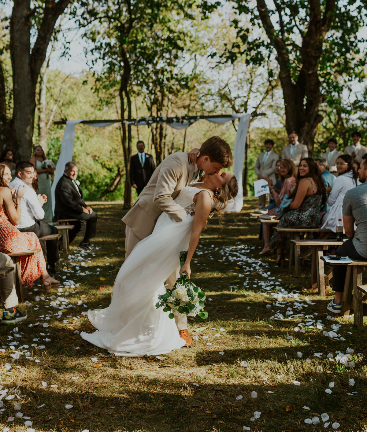 Bride walking down outdoor aisle, rustic Indiana wedding vibe.