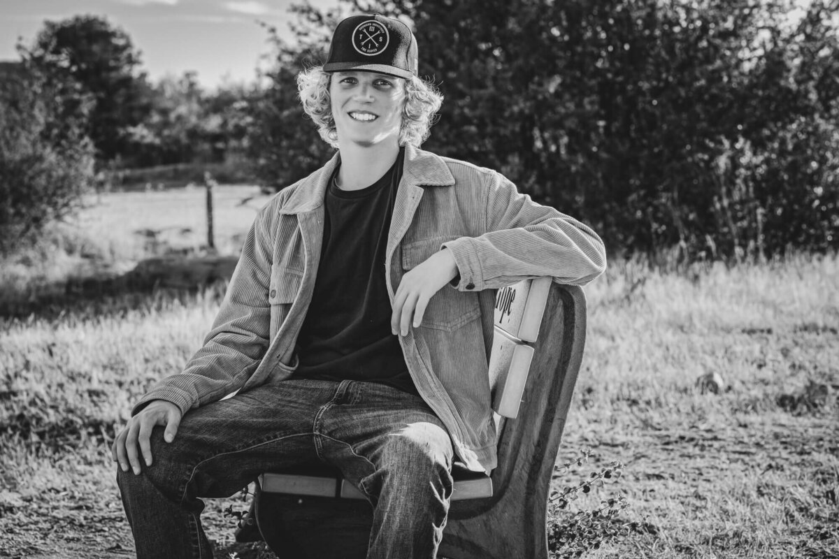 Boy poses on bench in Prescott senior photography session