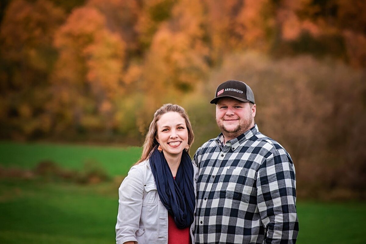 husband and wife with fall foliage