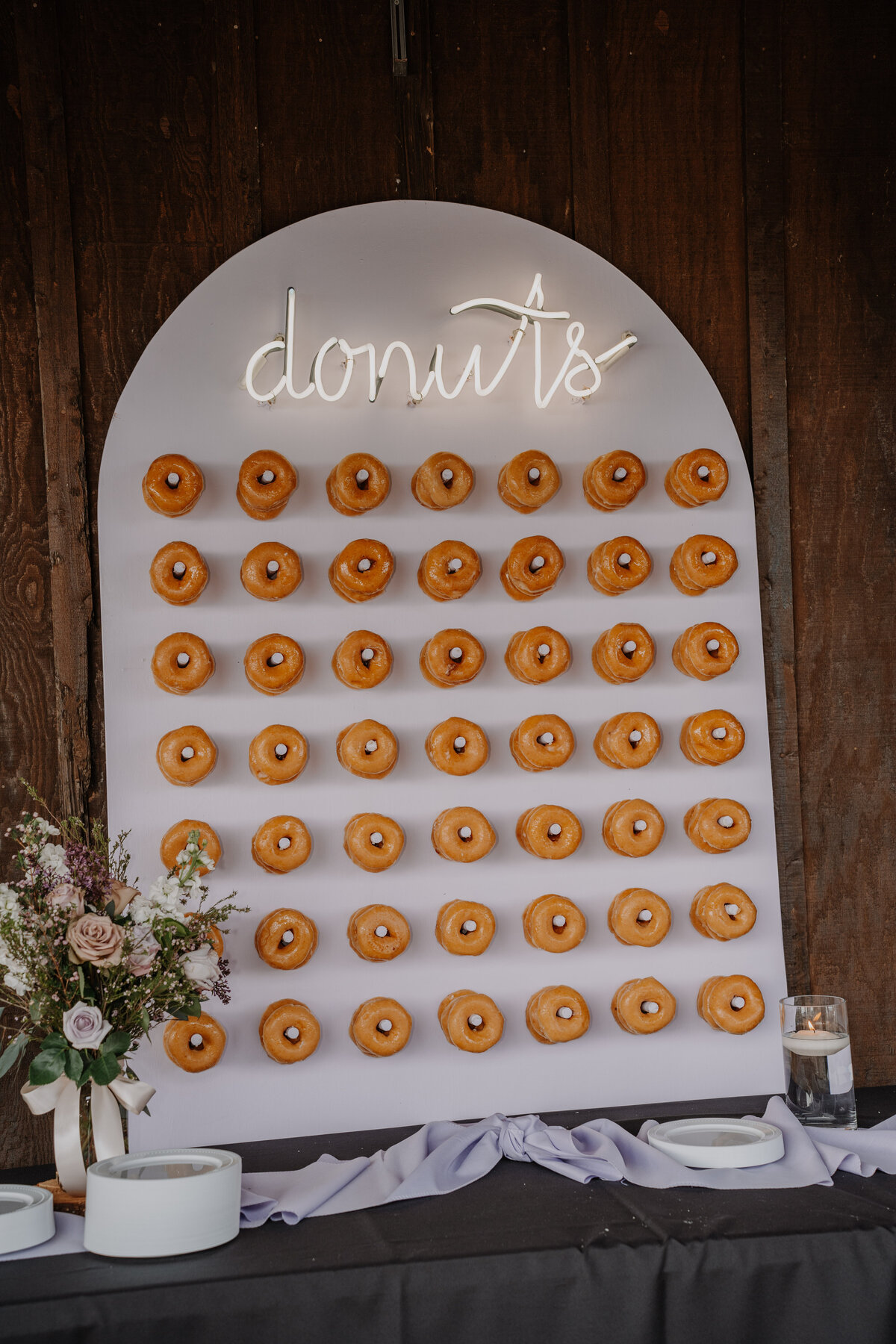 Board with pegs holding doughnuts