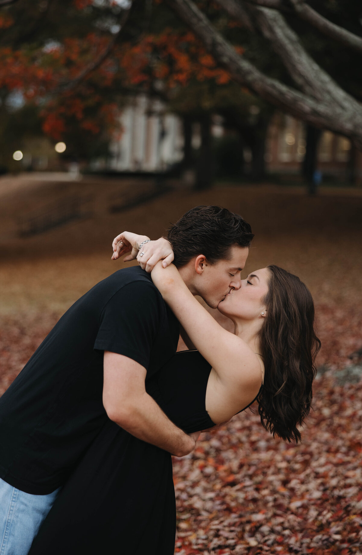 couple kissing under a tree