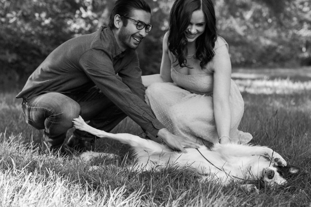 Fun and joyful engagement session Woodinville WA near Seattle happy couple laughing with their dog candid photo by Joanna Monger Photography