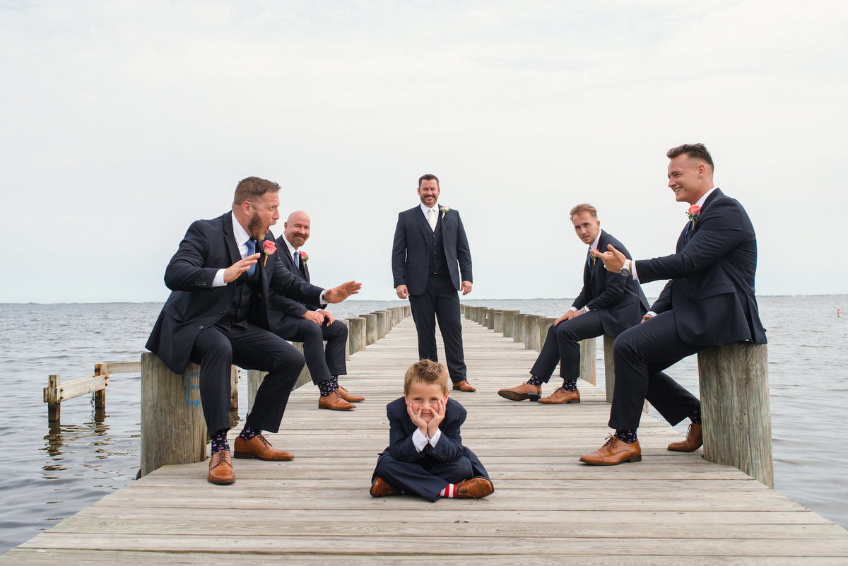 photo of groomsmen on the dock with ring bearer from wedding at Lombardi's on the Bay