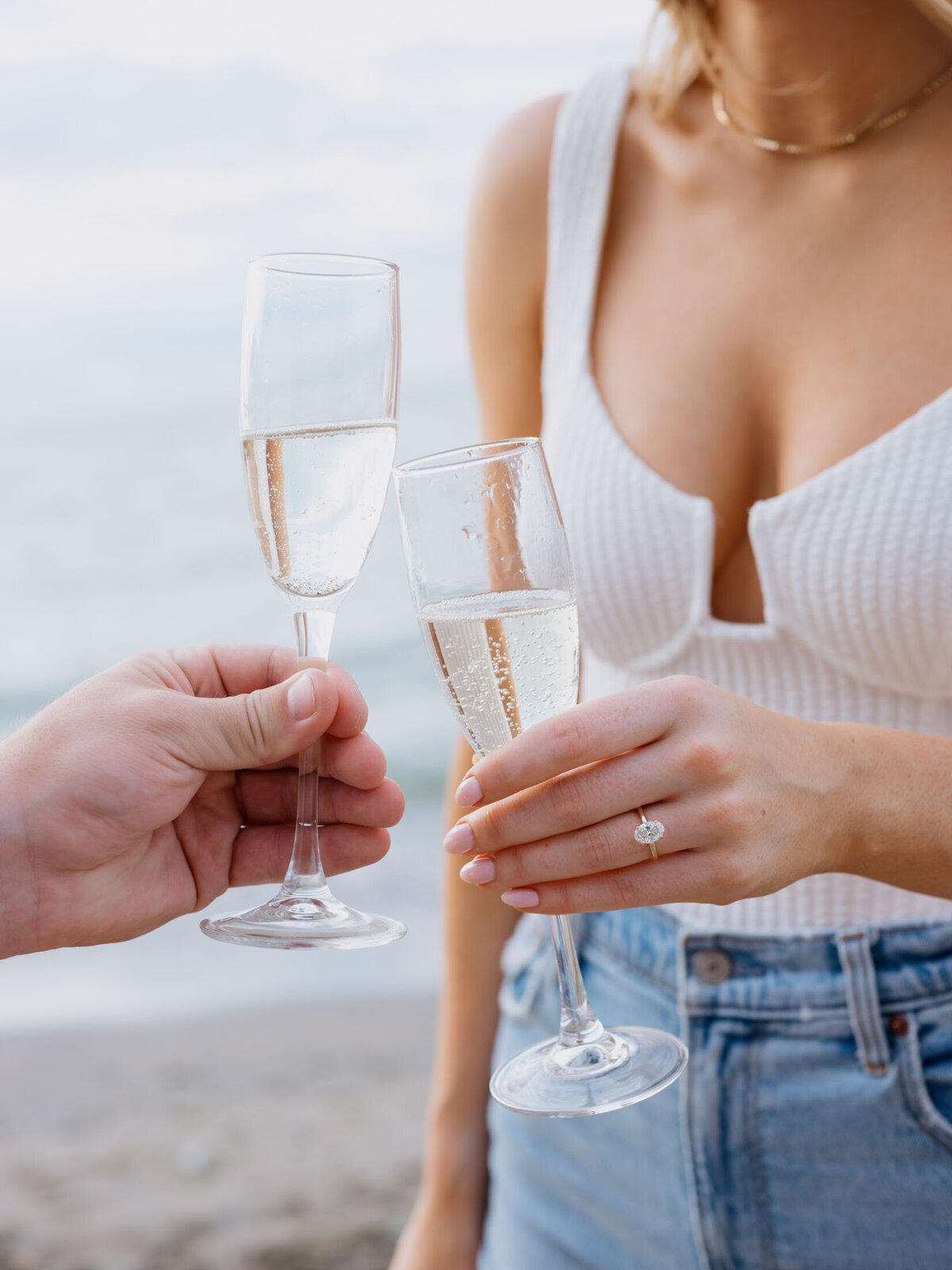 Couple with champagne glasses celebrating their engagement.