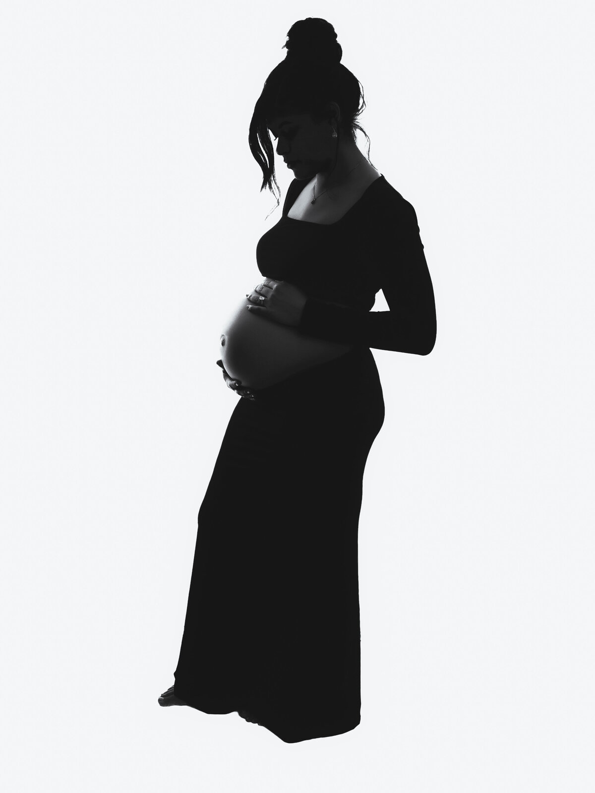 a pregnant woman looking at her belly