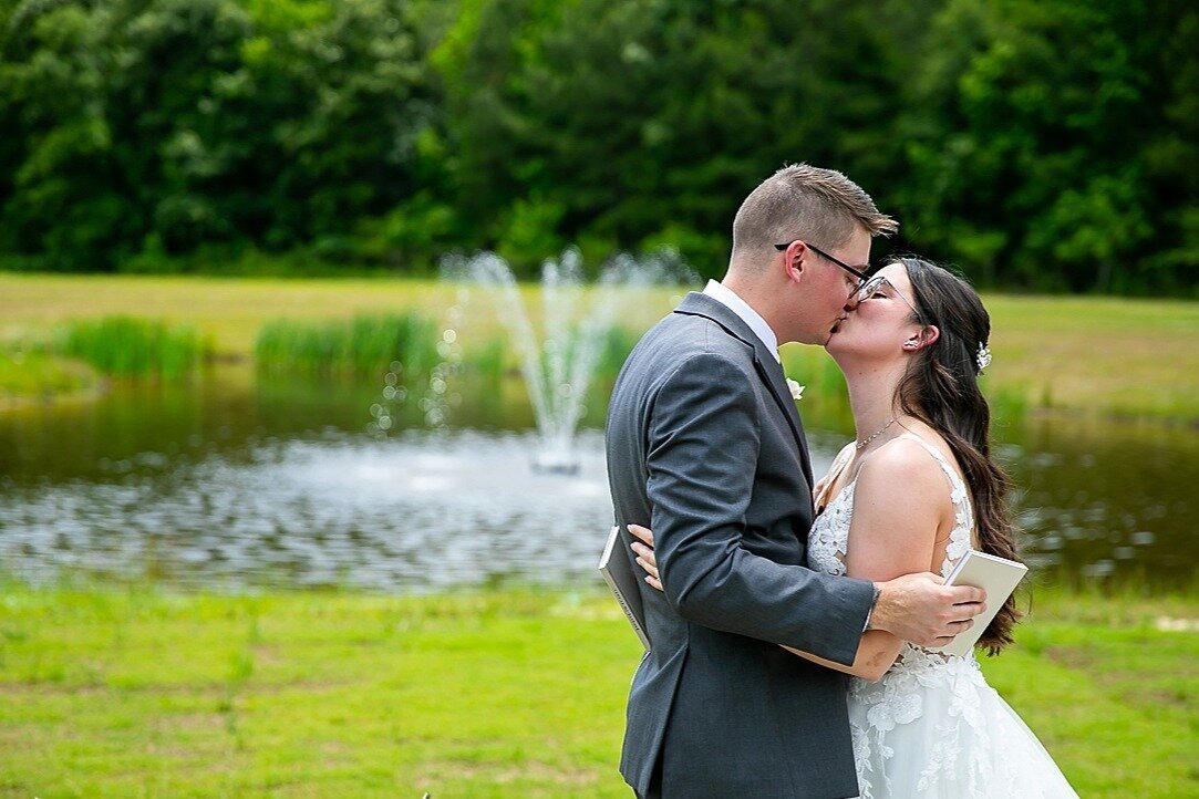 Veranda-Lawn-Fountain-Bride-Groom-Kissing-The-Legacy-at-Willow-Pond.JPG