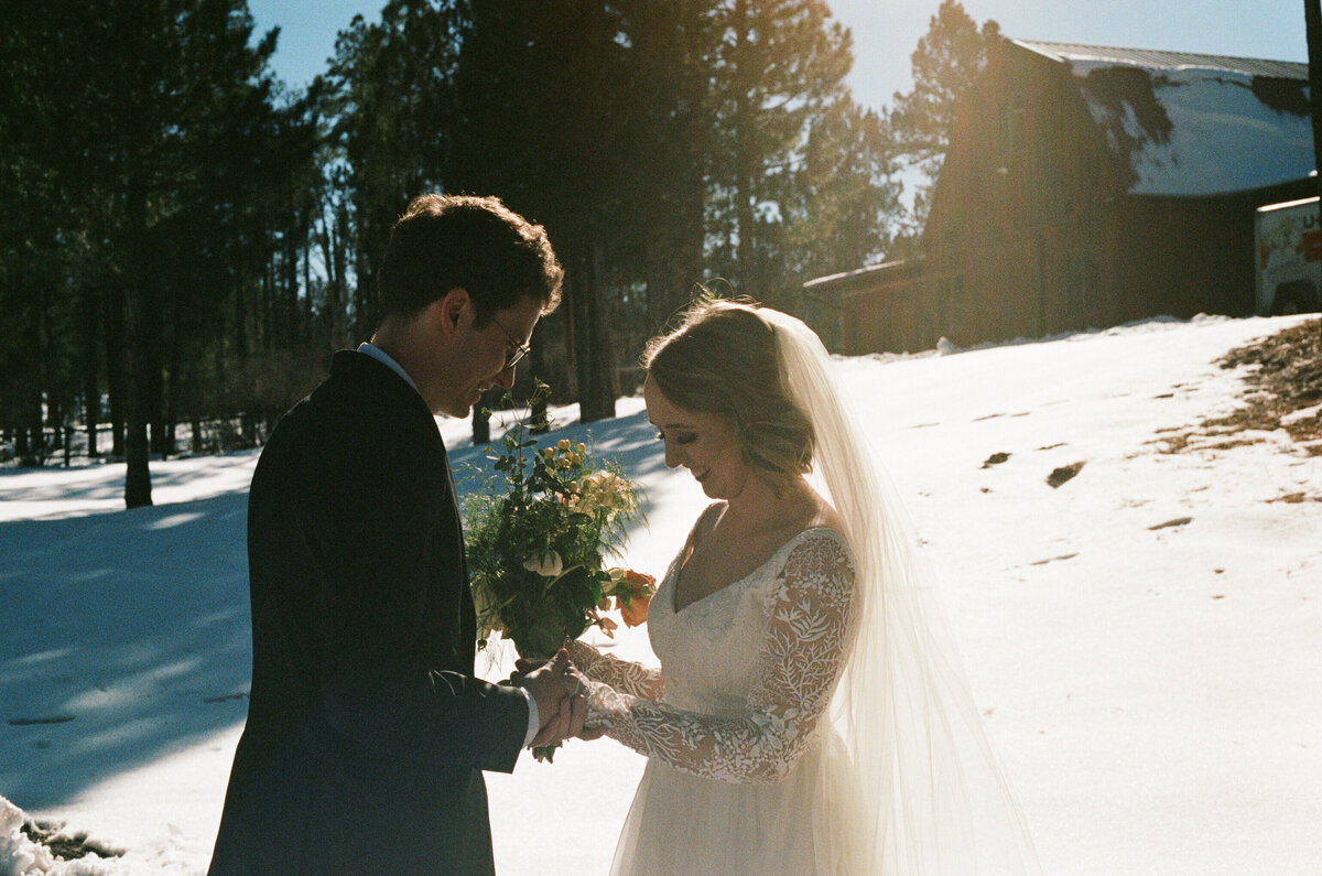 bride and groom standing in snow in northern arizona on portra 400