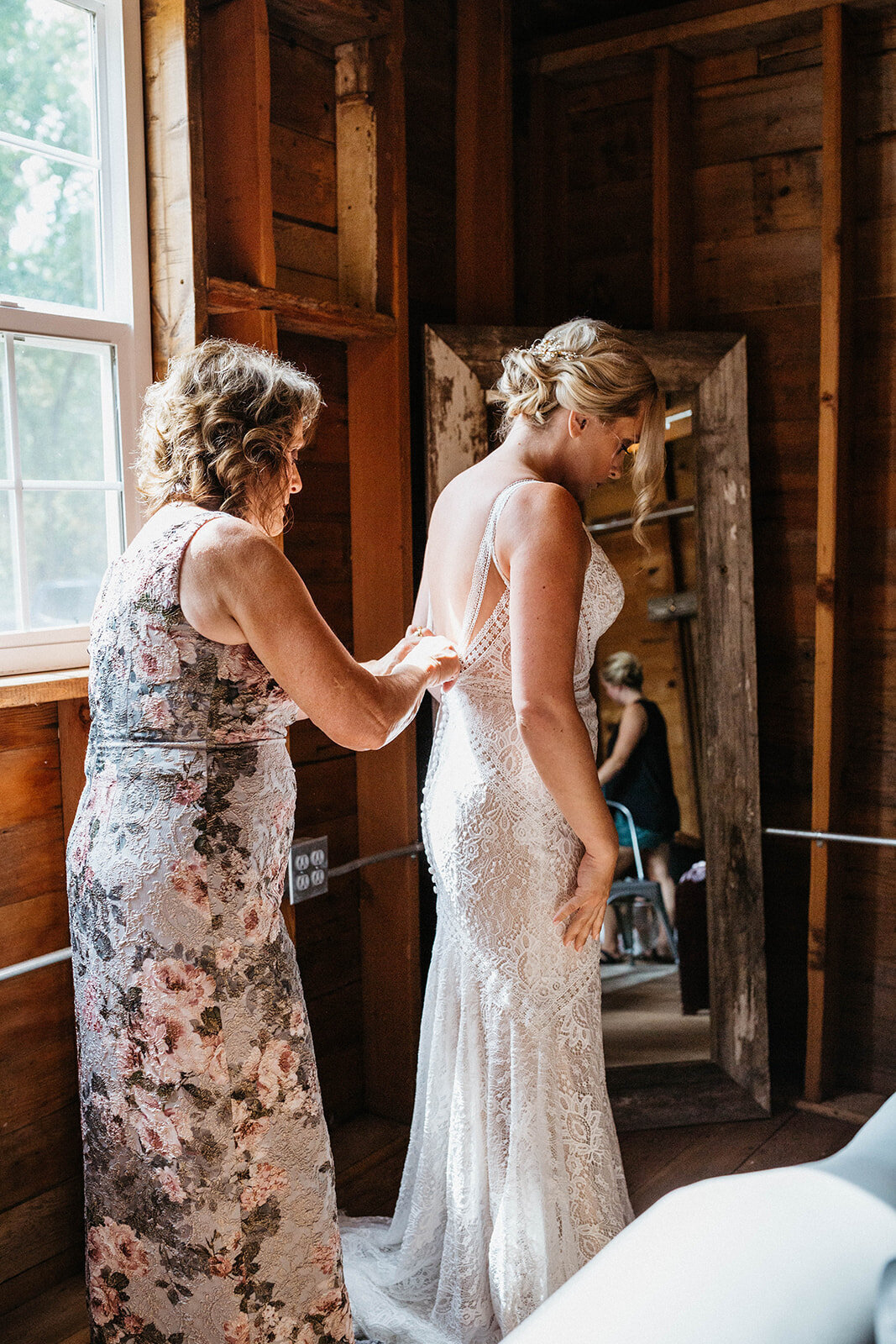 mom-helping-bride-get-in-dress