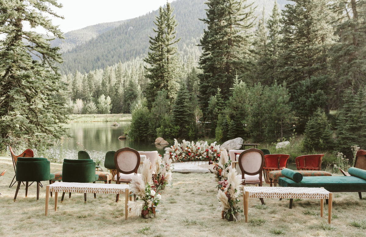 Chairs are set up for a wedding ceremony infront of a lake