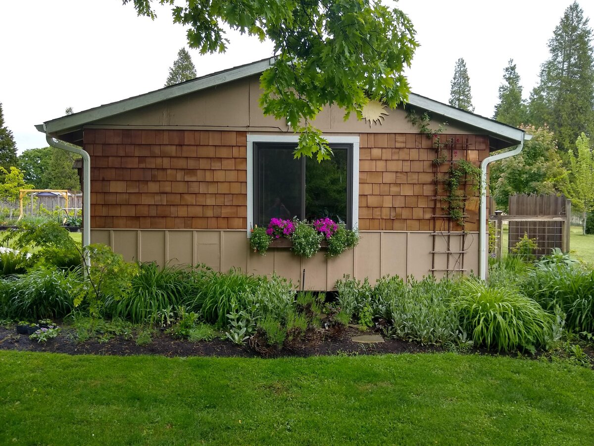 Grass, garden bed, flower box and cottage.