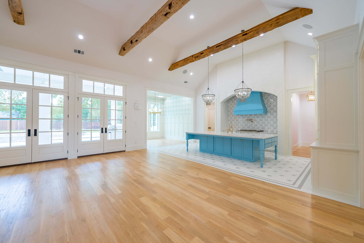 Cottage custom home with bright blue kitchen