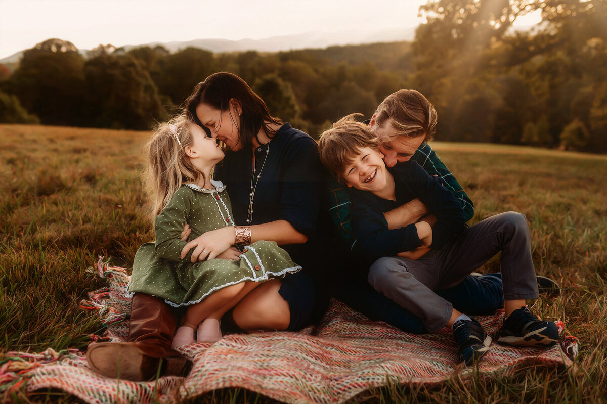 Parents embrace their children during Family Pictures at Biltmore Estate in Asheville, NC. 