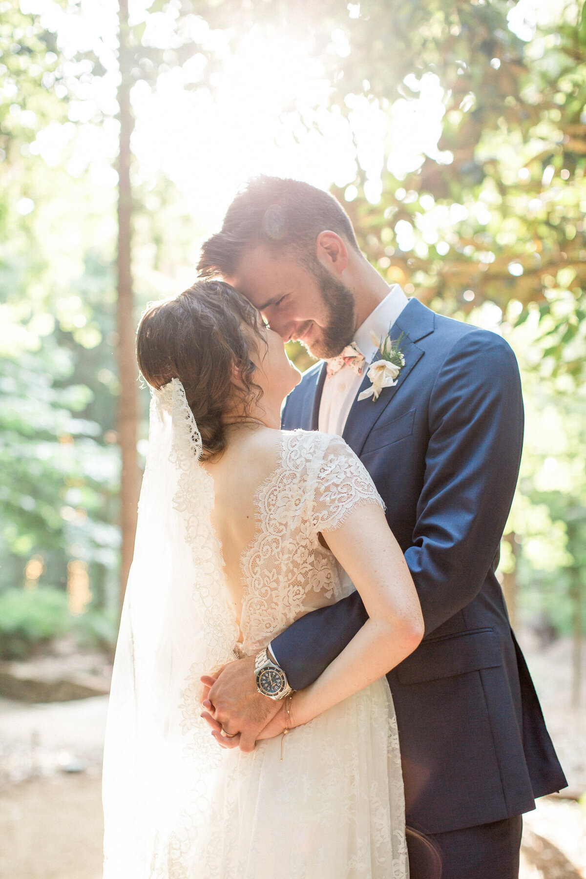 A  joyful groom wraps his arms around his new bride in a close embrace