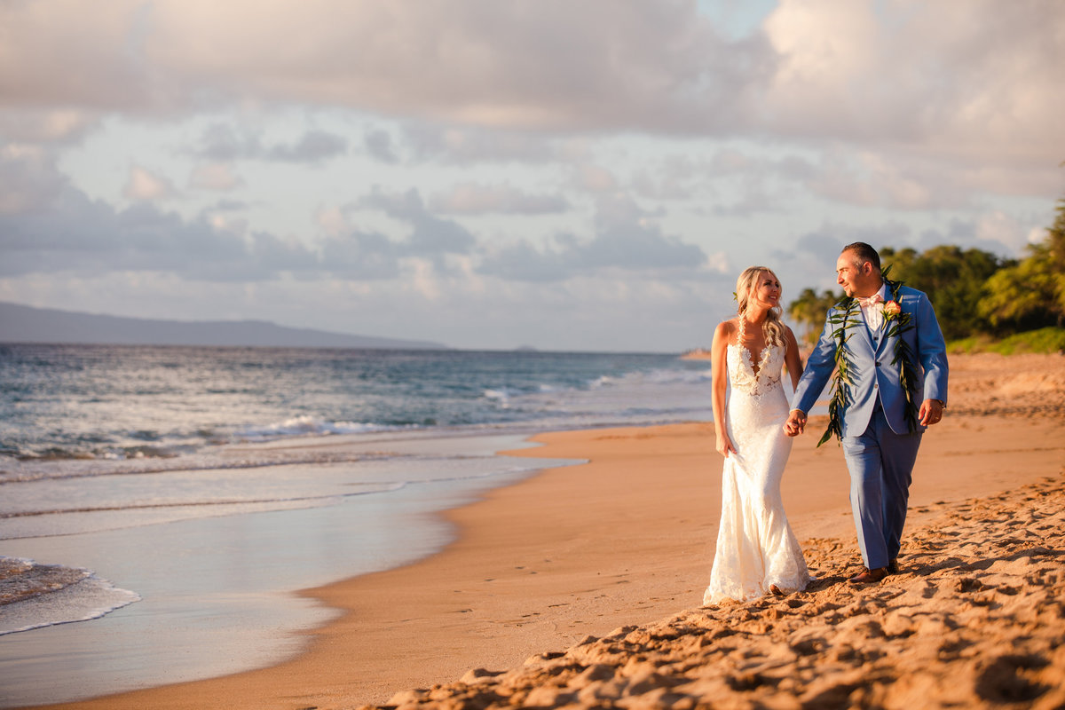 Bride and Groom holding hands on the beach of Maui