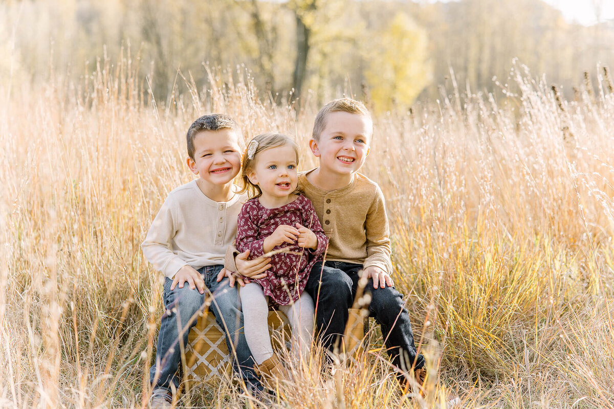 Three siblings smile for their family session in Mankato, Minnesota.