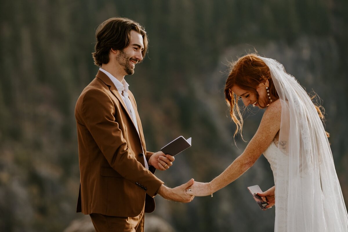 couple laughing in yosemite national park saying their vows at taft point