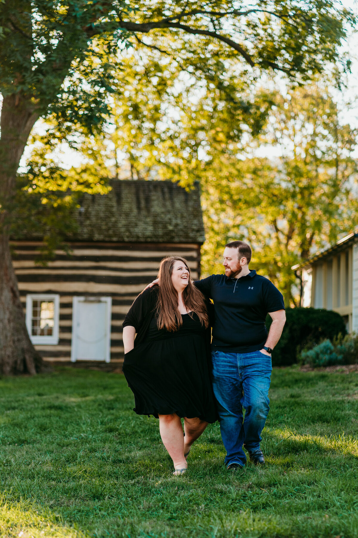  Couple strolling in front of rustic cabin