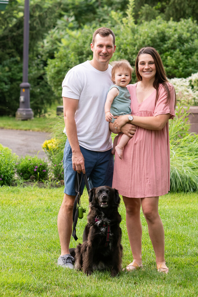 Happy family with toddler and black dog
