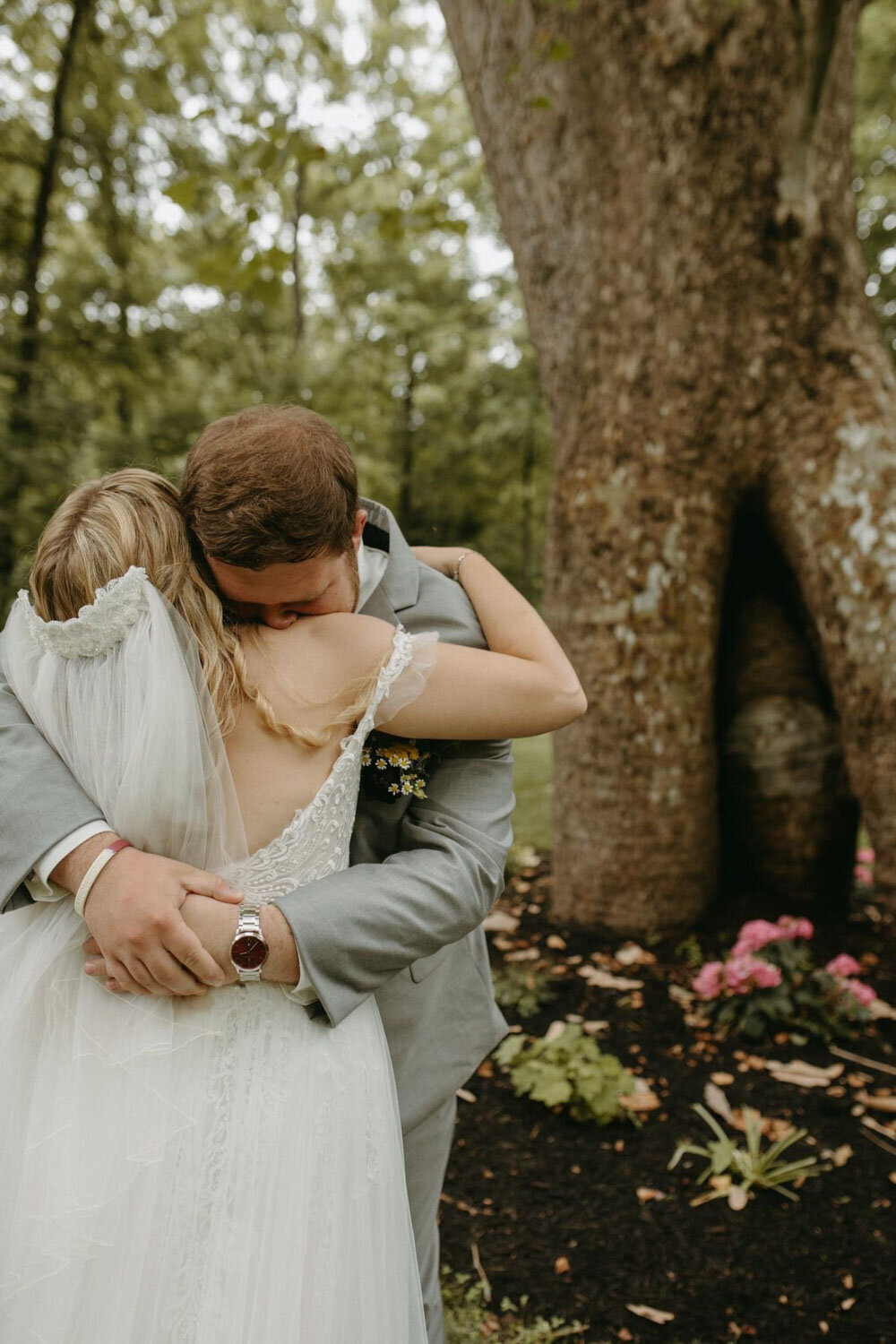 Bride and groom hugging in front of the sycamore tree