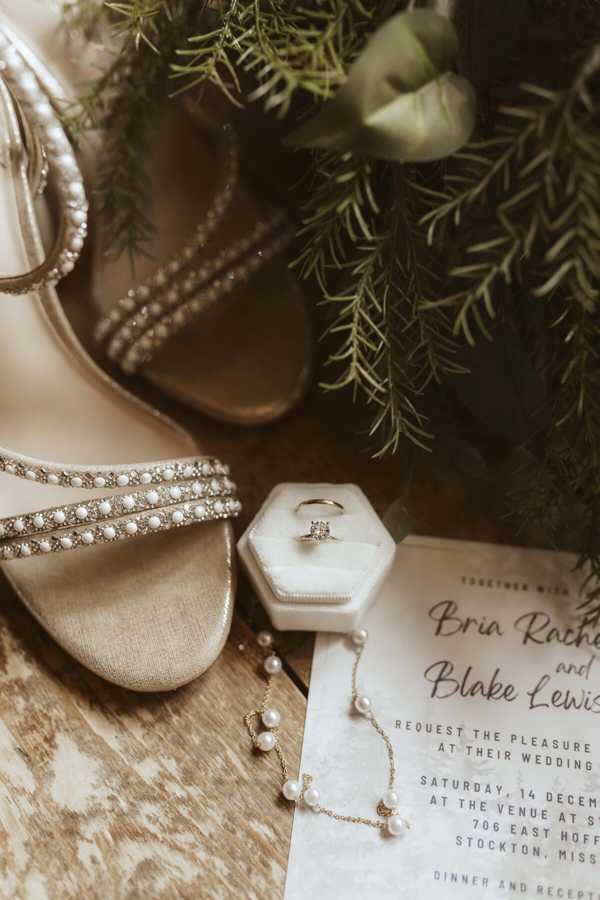 Winter wedding flat lay featuring bridal details at wedding venue in Stockton Missouri