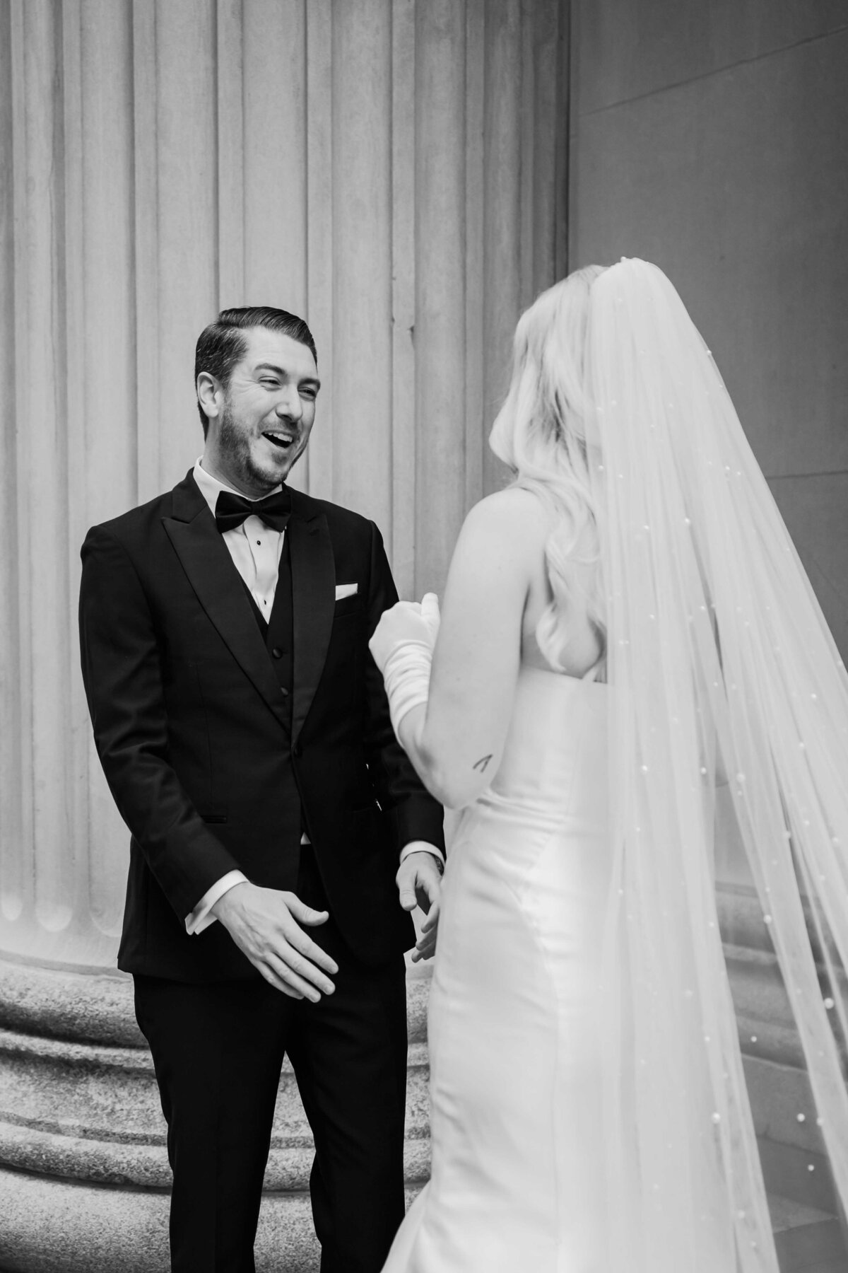 Groom reacts after seeing bride in wedding dress