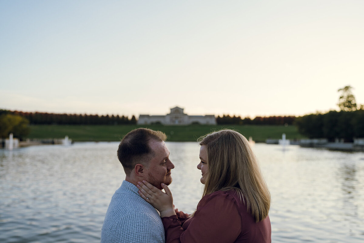 engaged couple looking into each others eyes by the grand basin