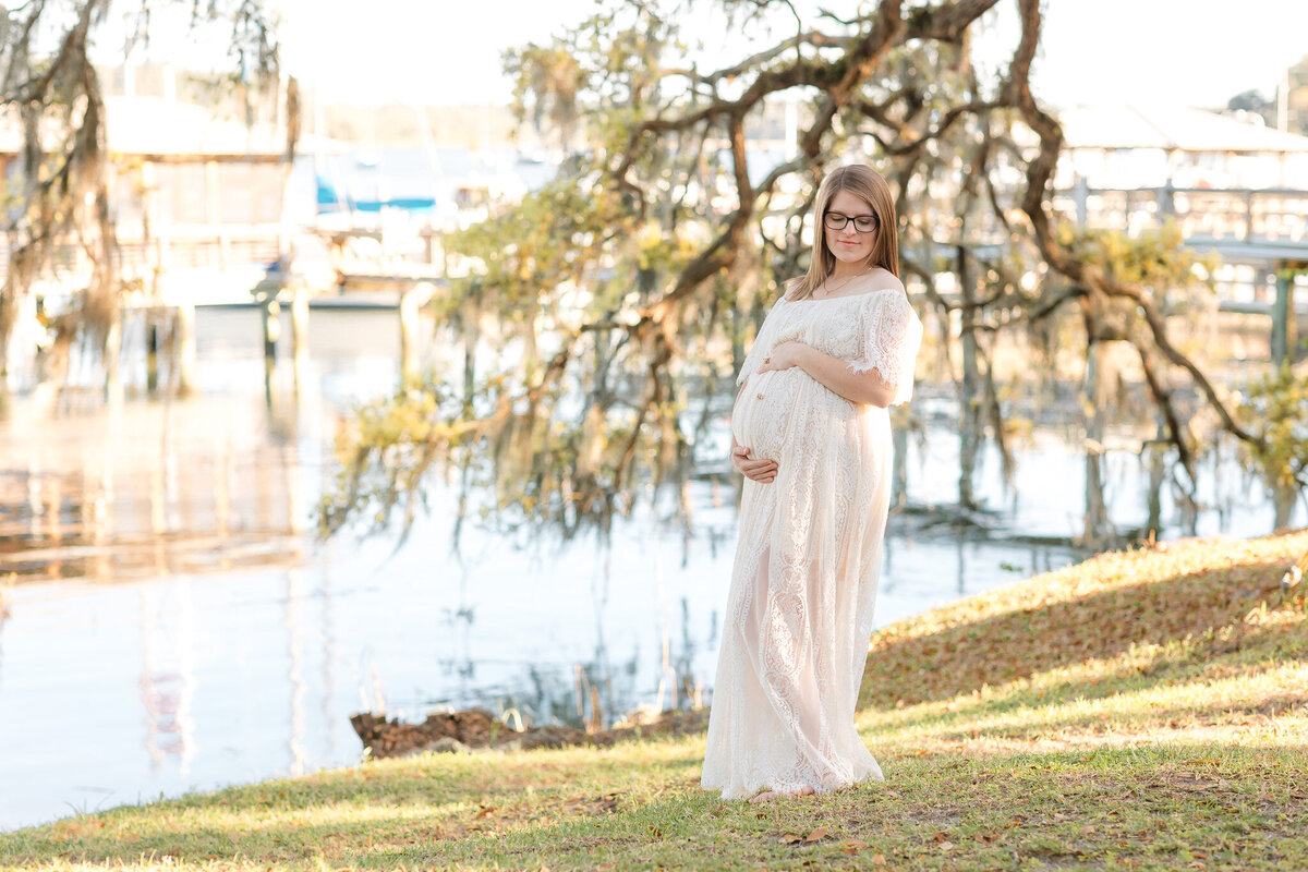 Second time mother holding her belly in Savannah, Ga for a maternity session