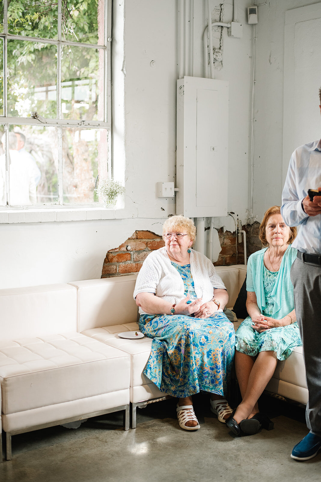 Emotional reaction from a guest during a heartfelt wedding speech, captured in an authentic, documentary style.