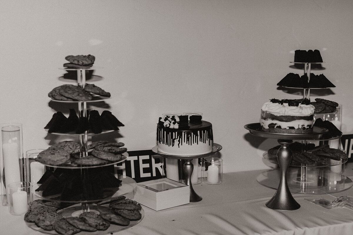 Alana and Ryan's dessert station on their wedding day in a black and white photo