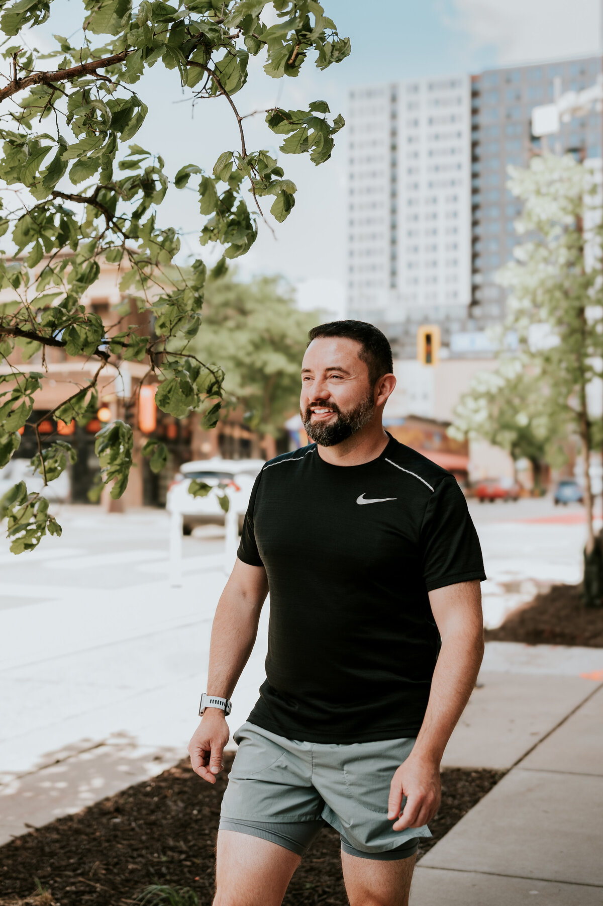 Online dating profile photo of a man in activewear, walking confidently in the Twin Cities, designed for dating apps that attract outdoorsy matches.