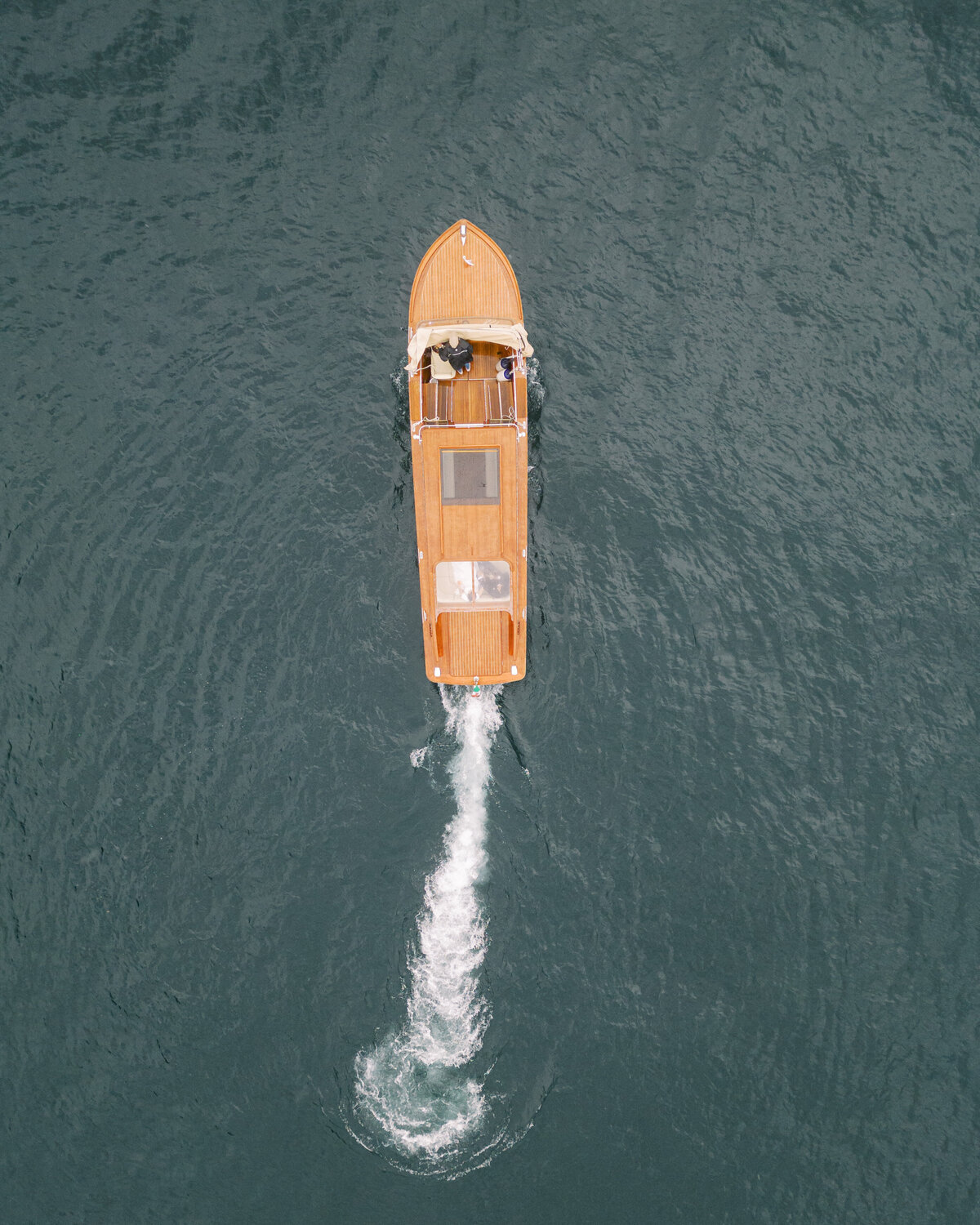 Drone photograph of bride and groom on boat on Lake Como