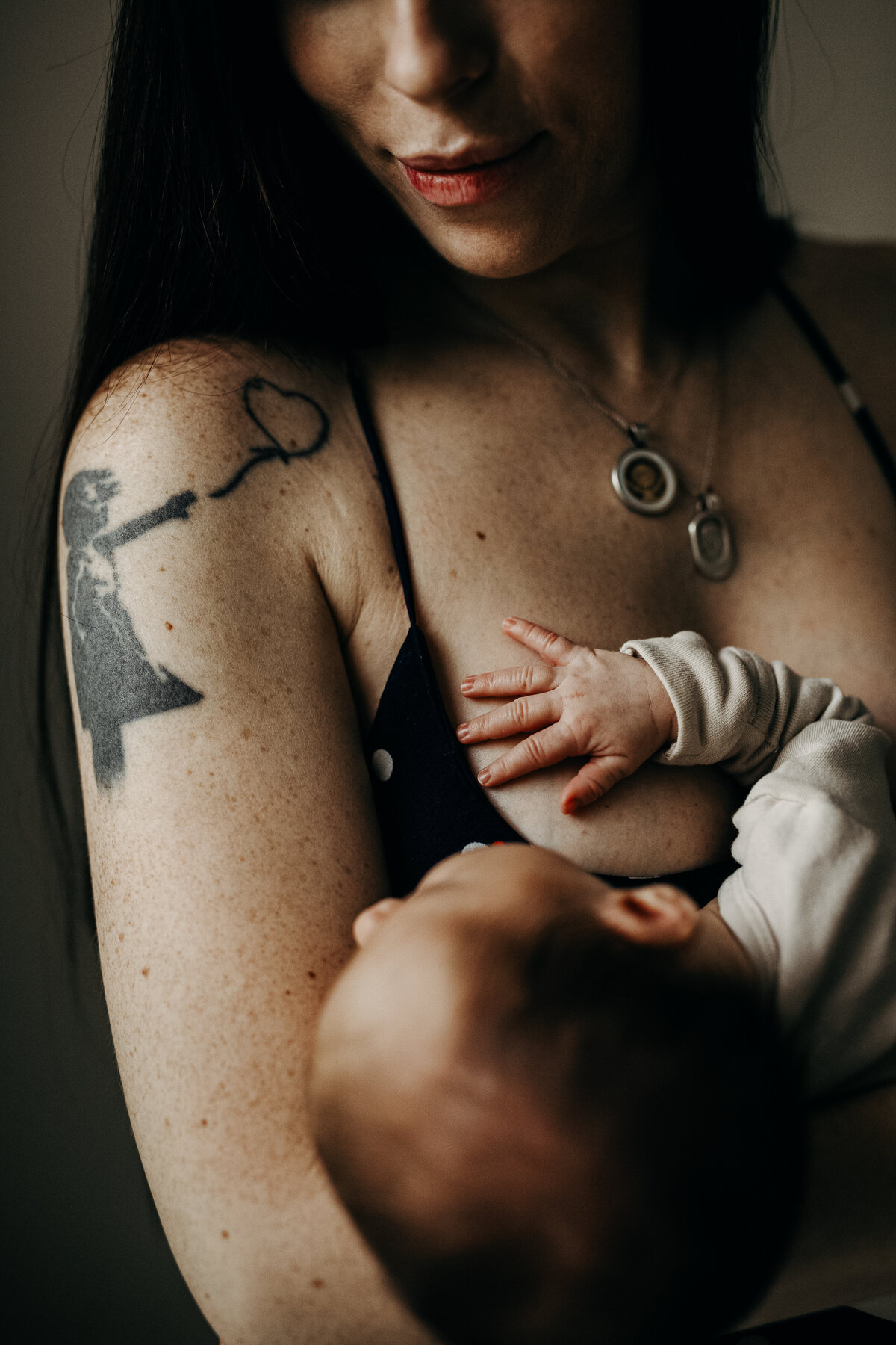 mom holding baby in the nursing position