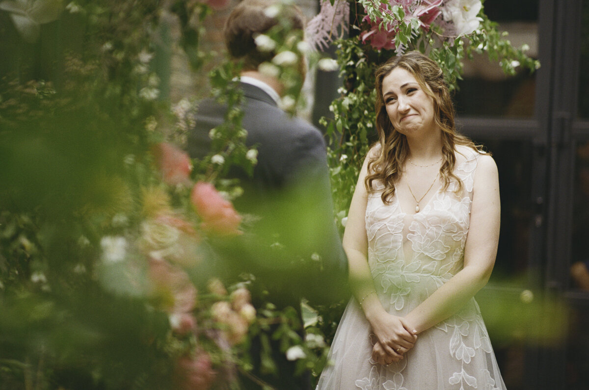 Soft romantic ceremony reaction photo of a bride crying on 35mm film at Milk & Roses