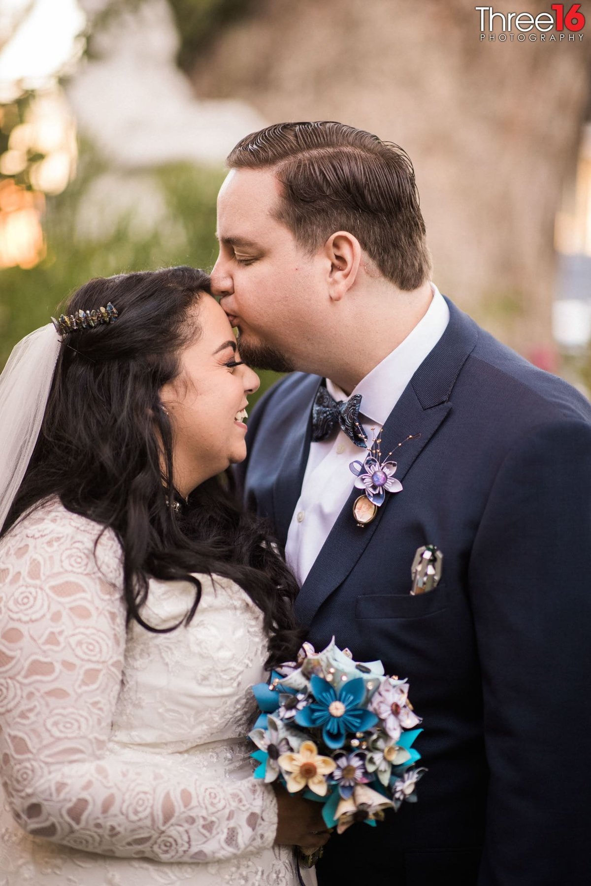 Sweet moment as Groom kisses his Bride's forehead
