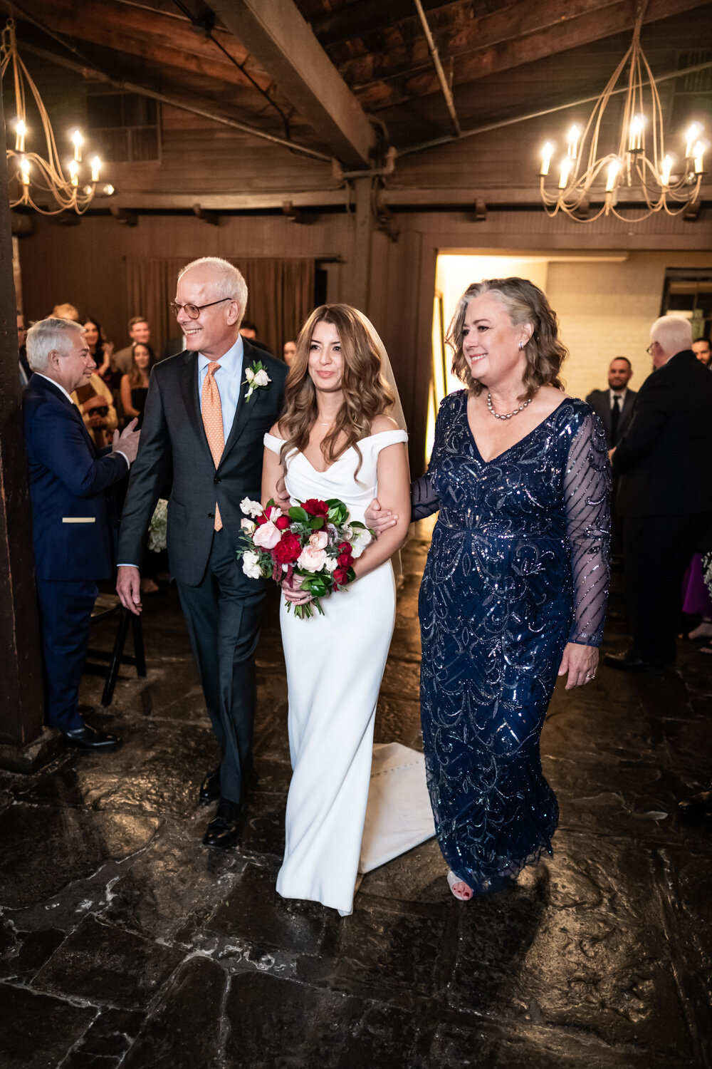 Bride walks down the aisle with parents