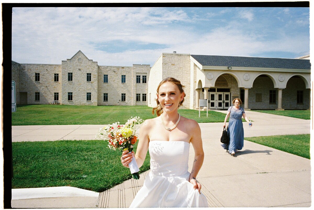 Bride is walking out of the church after her wedding ceremony and family portraits shot on kodak ultramax film