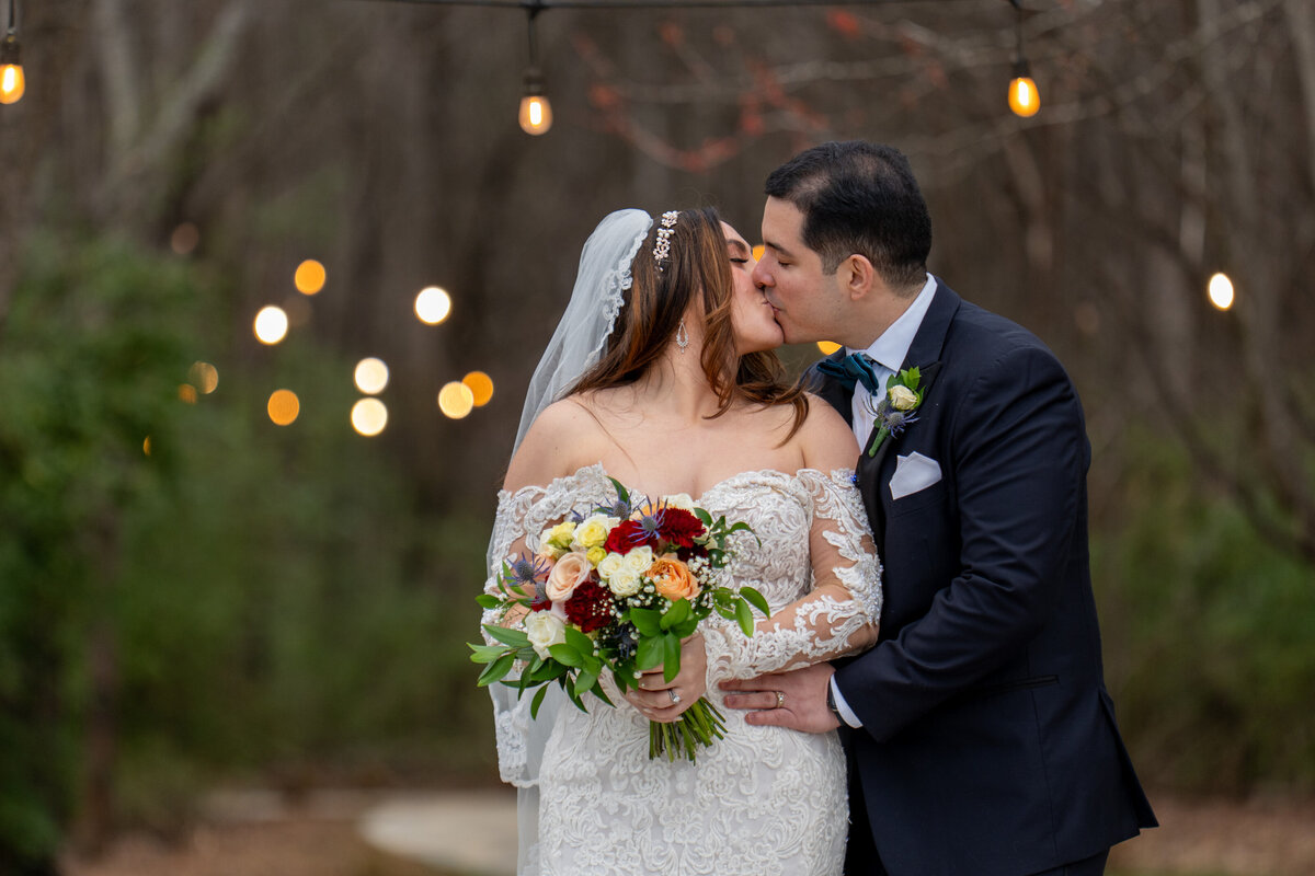 a newlywed couple kissing 