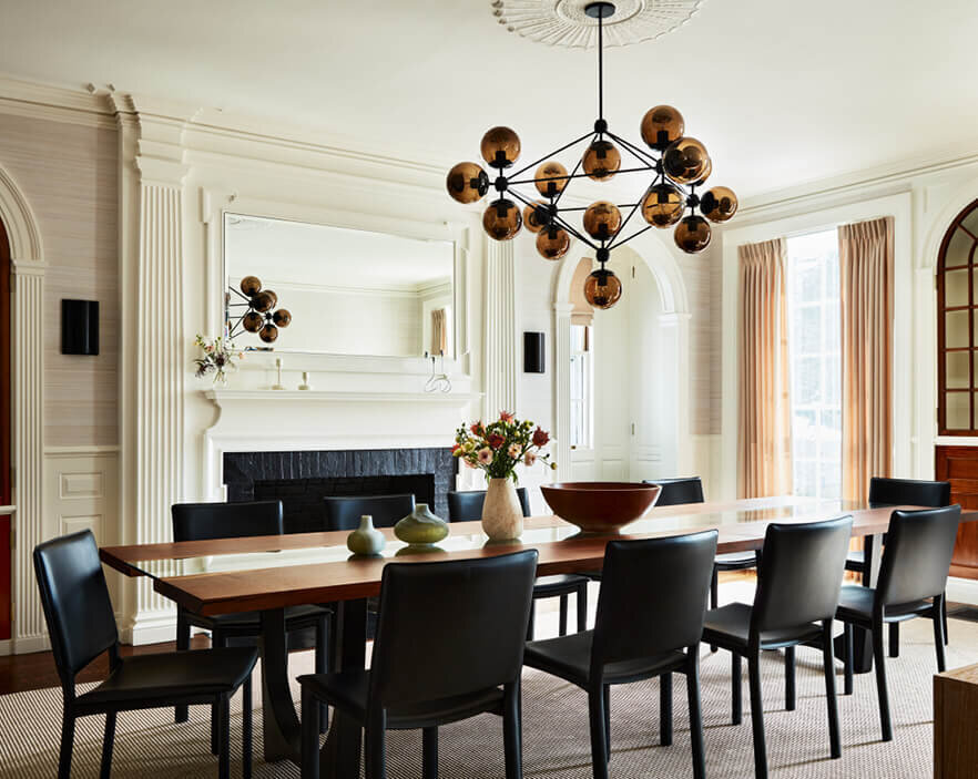 A Roll & Hill Modo chandelier highlights modern furniture in a historic dining room by one of Boston’s top interior design firms.
