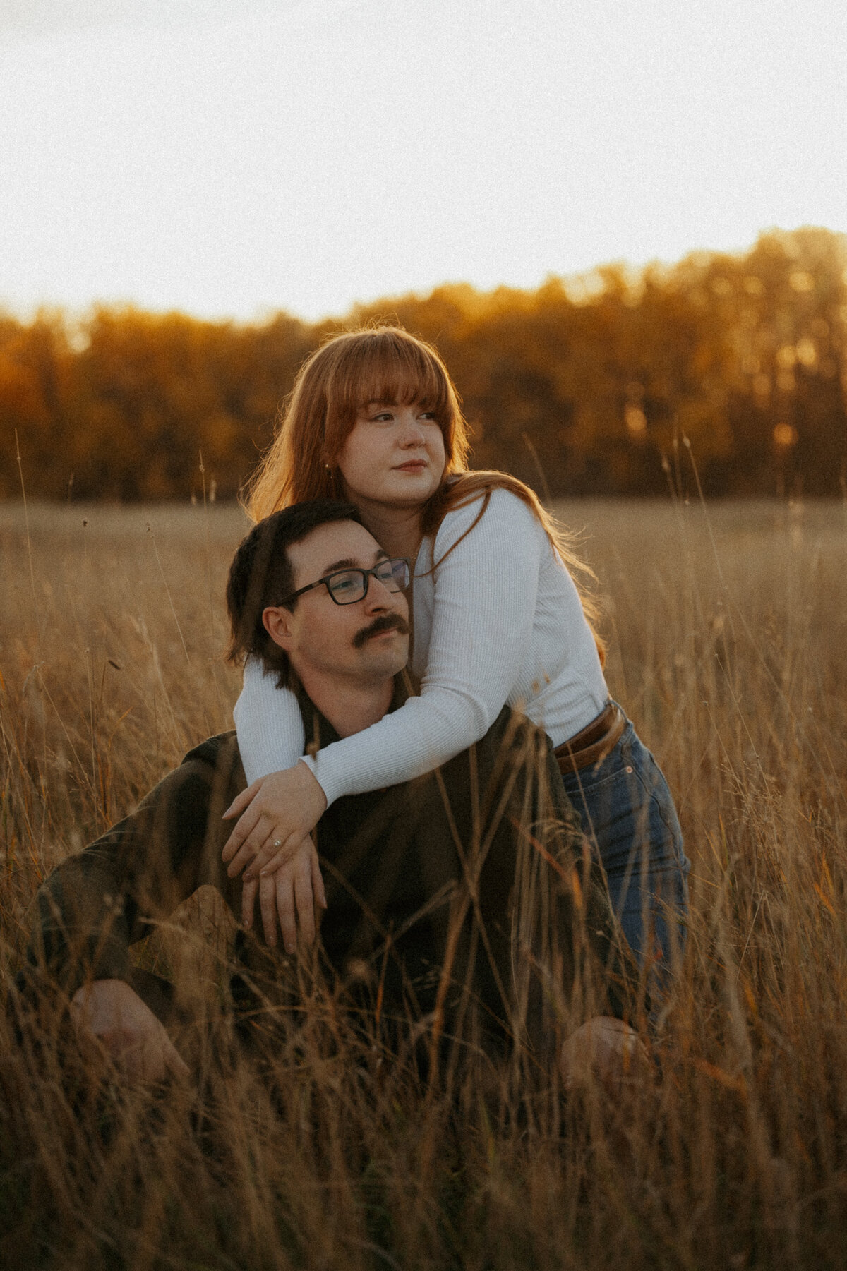 Couple posing in farmers field taken by Edmonton Photographer