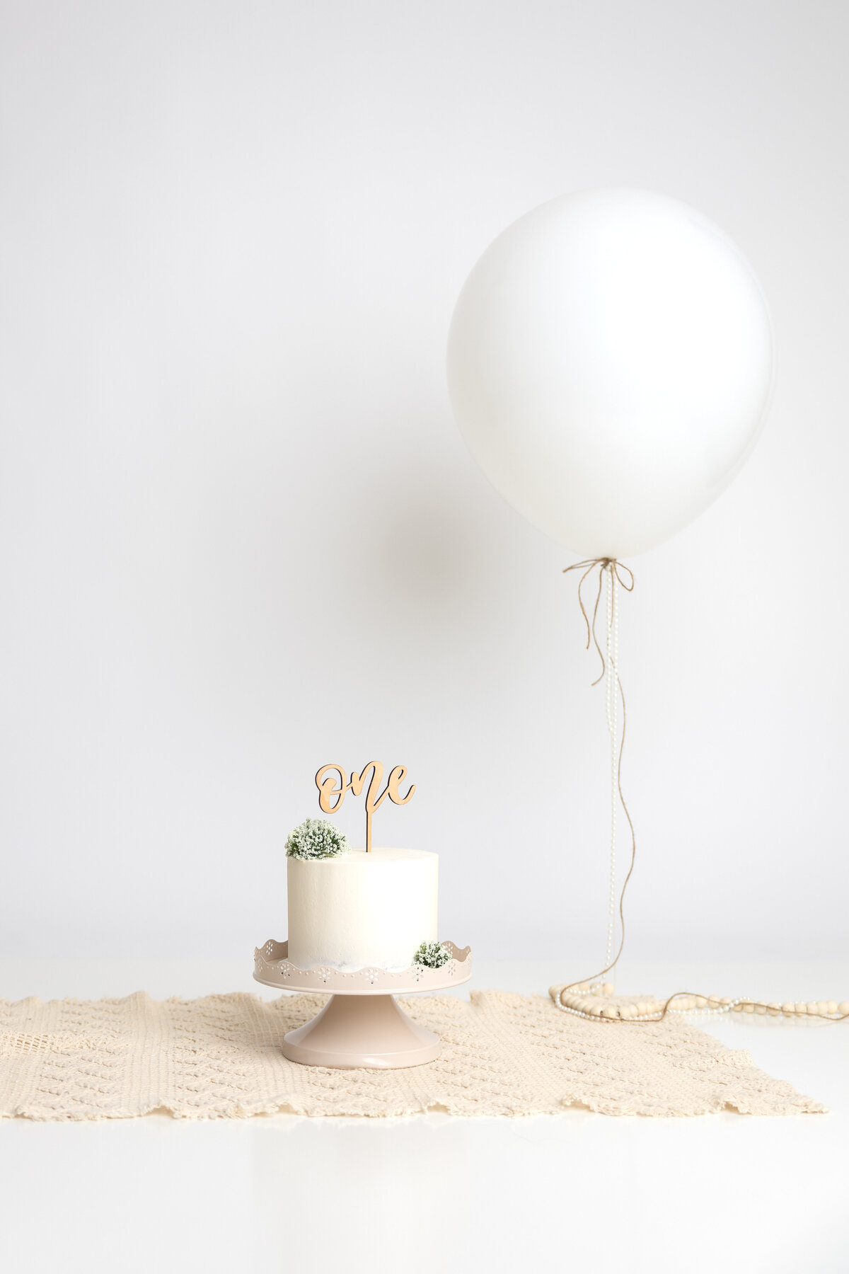 Minimalist white cake with extra large white balloon