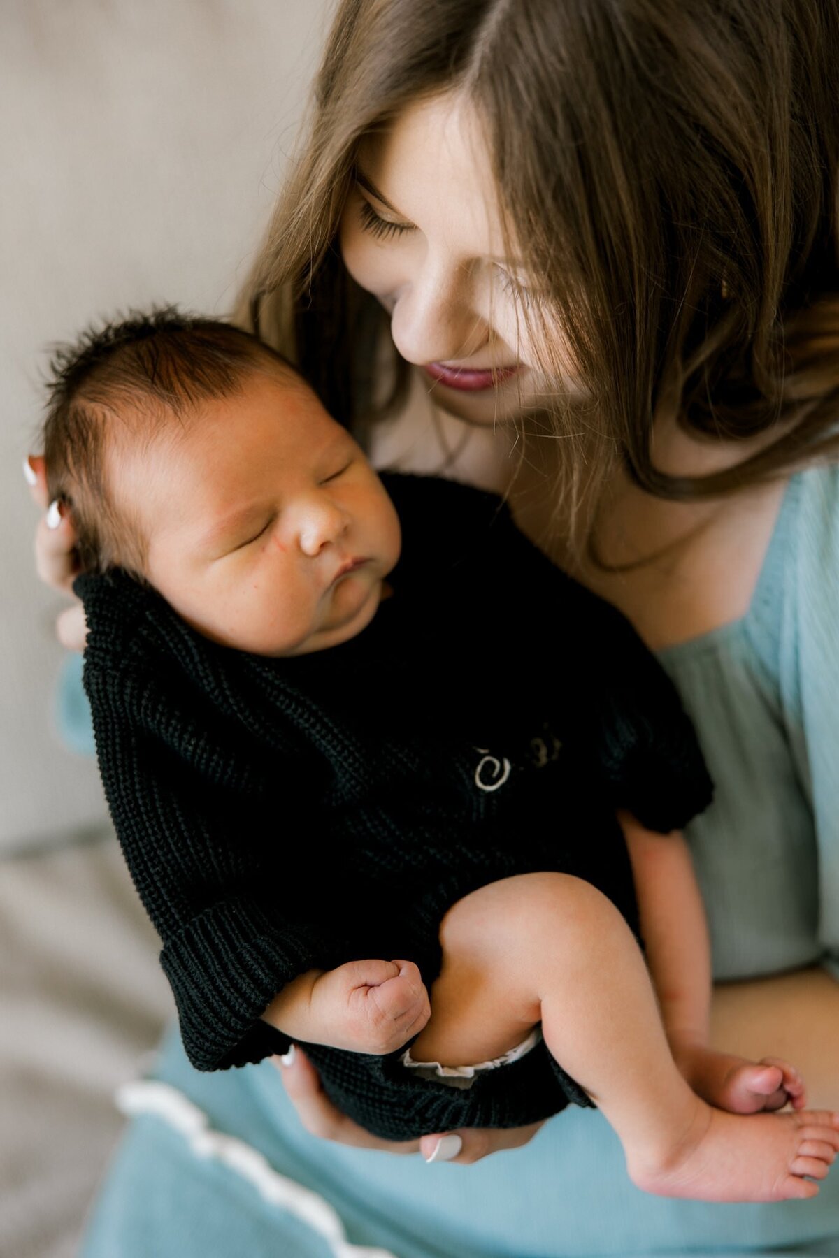 Momma smiling down looking at her baby boy. Photo captured by Lubbock newborn photographer Mary Wiebe Photography