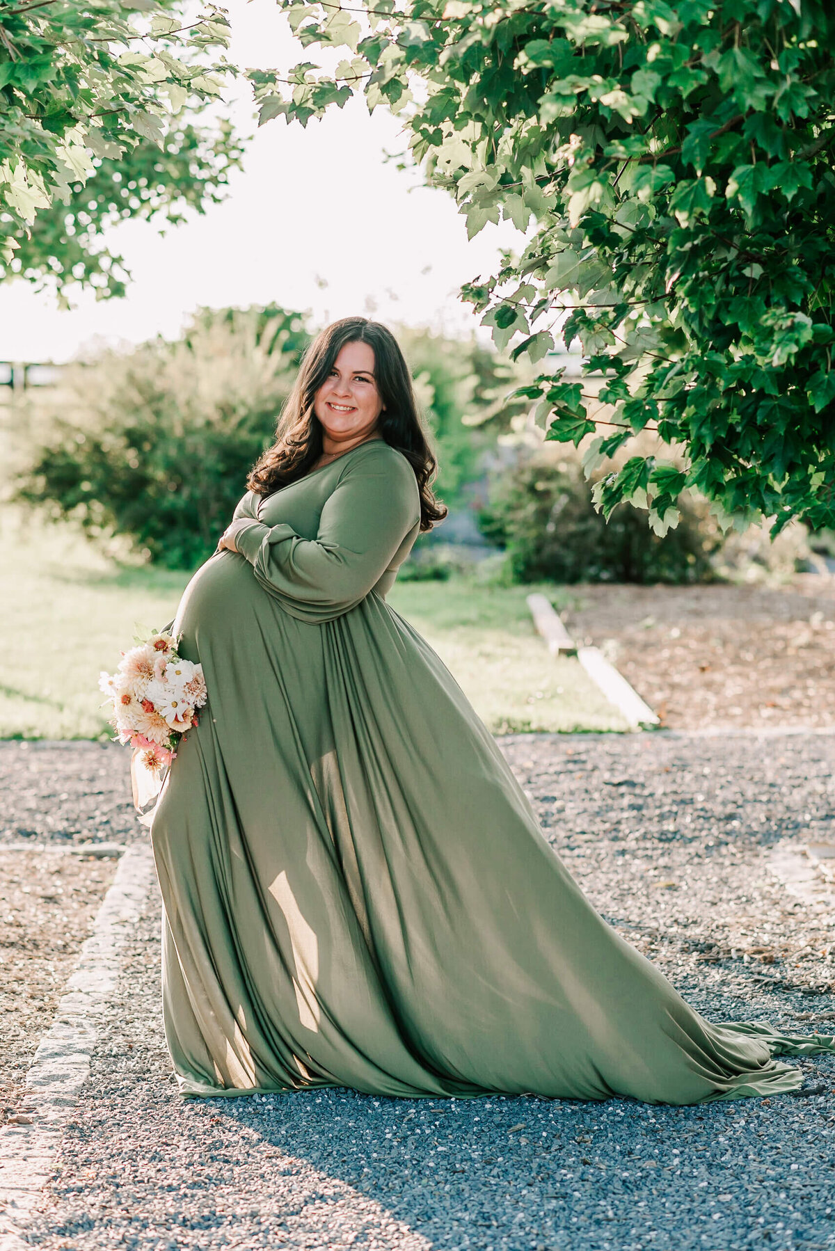 A pregnant mama wearing a green dress taken by denise van photography, a northern virginia maternity photographer
