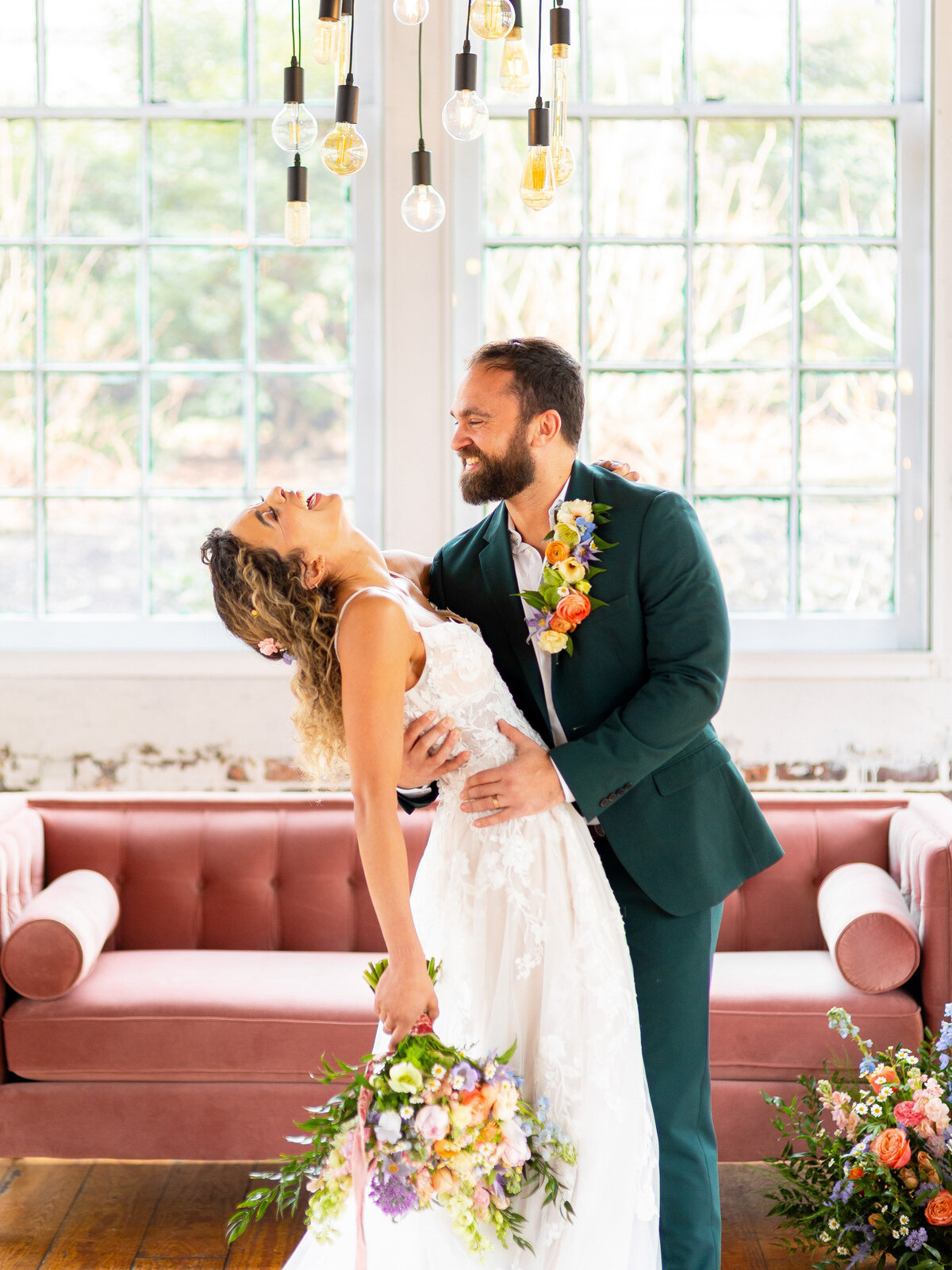 Bride and groom laughing while bride leans back