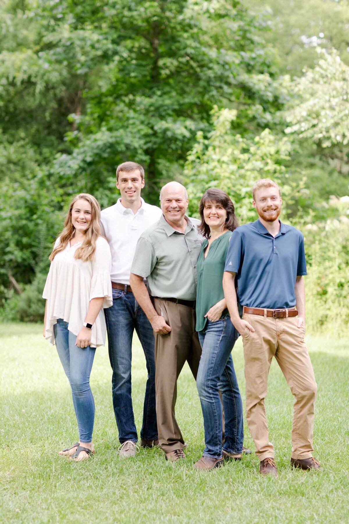 An older family poses confidently for their family portrait.