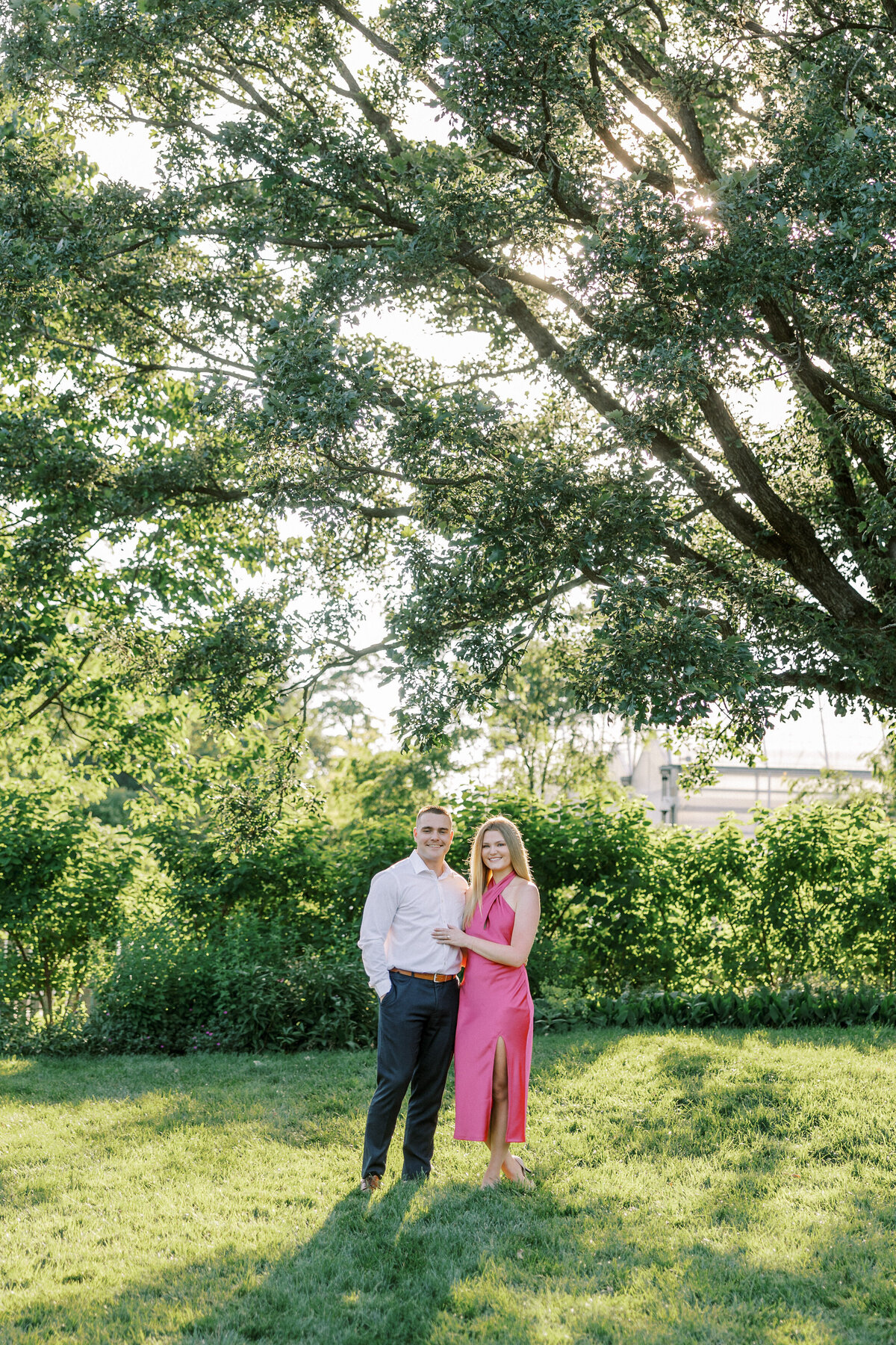 Engaged couple smiling surrounded by lush Columbus garden shot by Philadelphia photographer.