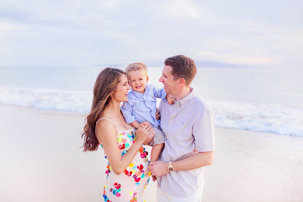 Young family smiles at the beach for the portraits at sunset with Love + Water Photo