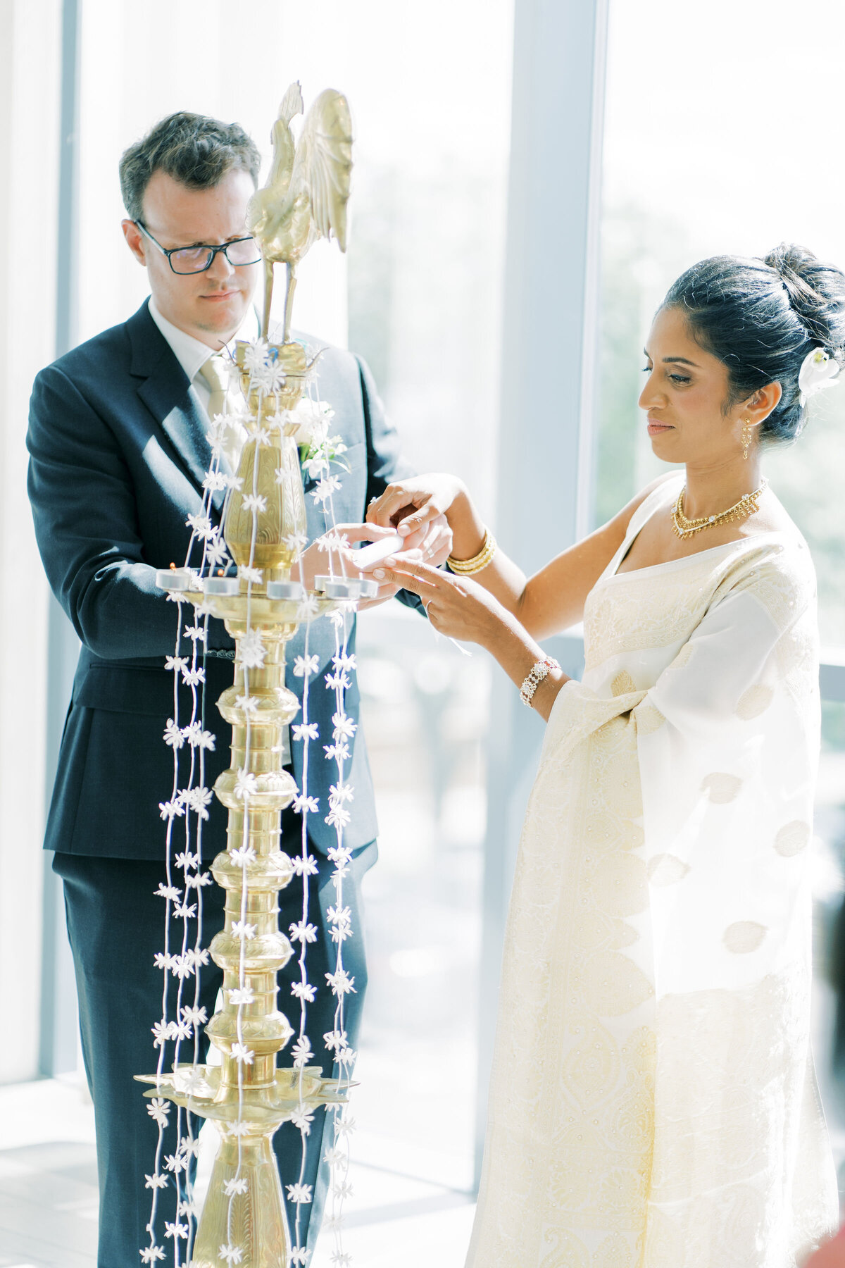 bride and groom light candles at the pearle hotel for their wedding.