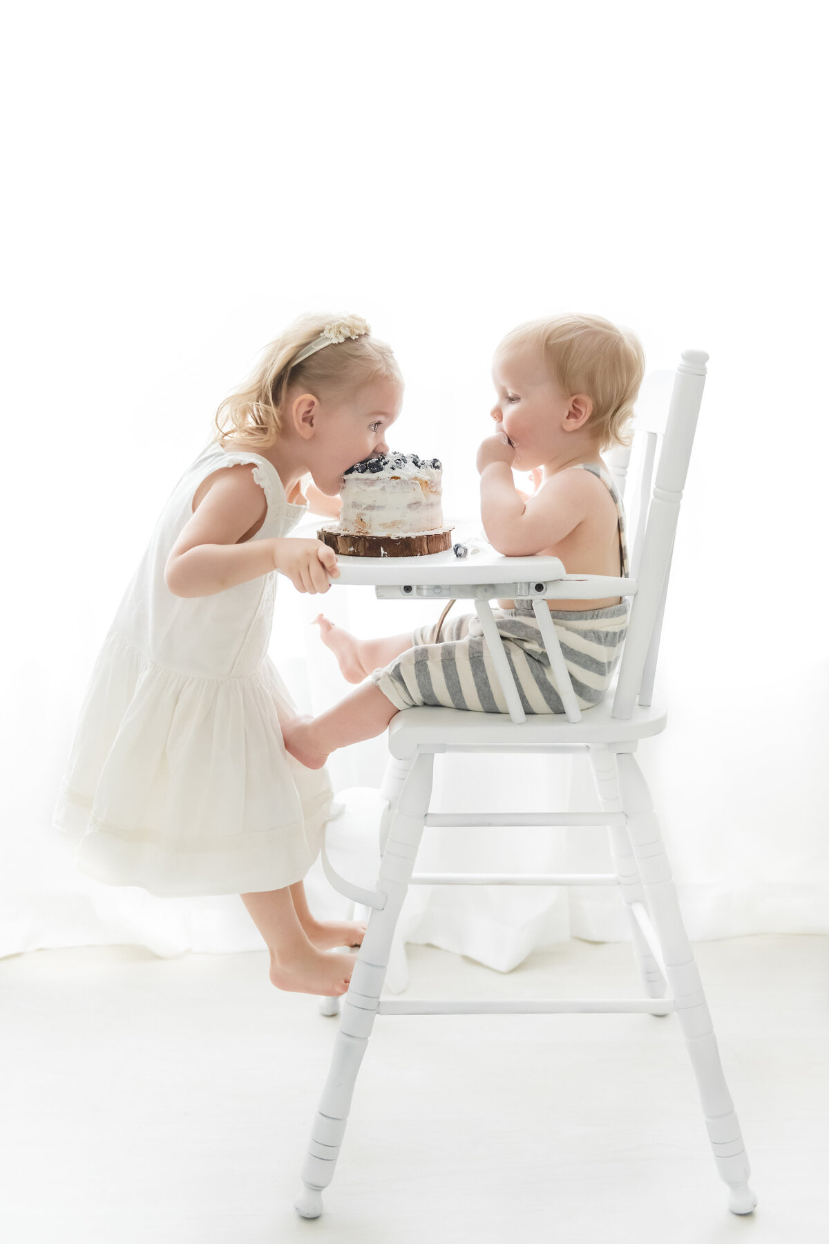 Phoenix first birthday cake smash photographer siblings in highchair